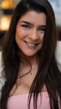 Captivating portrait of a smiling young woman with long dark hair in Milan, Italy.